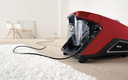Miele-Blizzard-CX1-Red-Lifestyle sitting idle in room plugged in